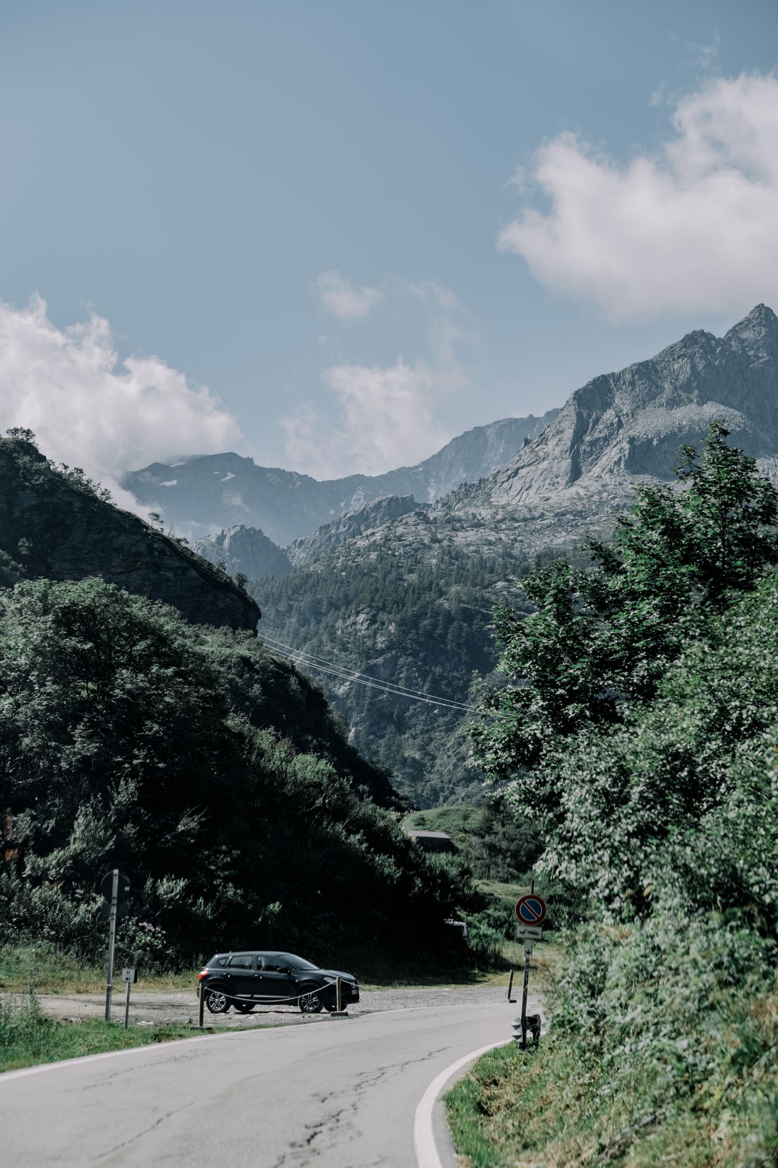 Car on a scenic mountain road through the Alps