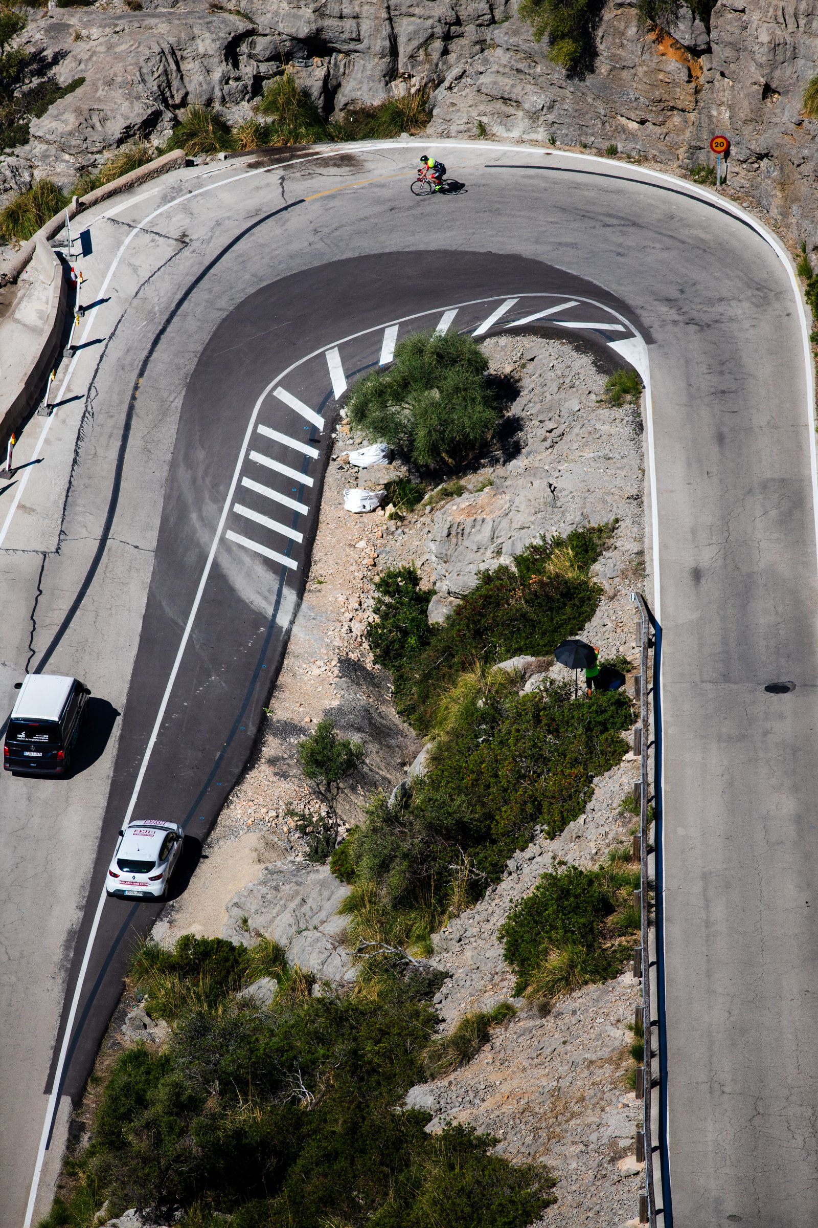 Aerial view of cars navigating a hairpin bend on a Mallorca mountain road