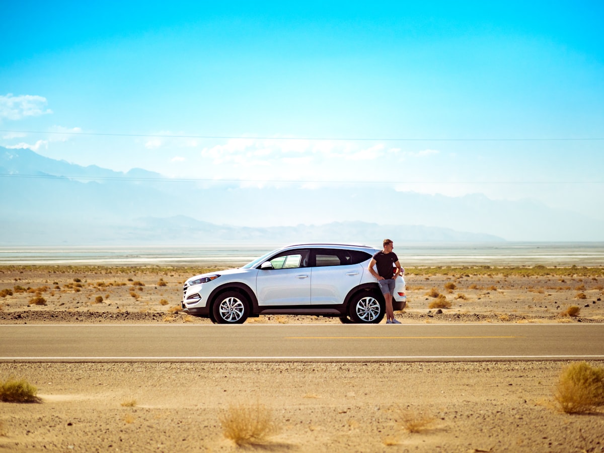 SUV with tailgate open and luggage for a summer road trip through Europe