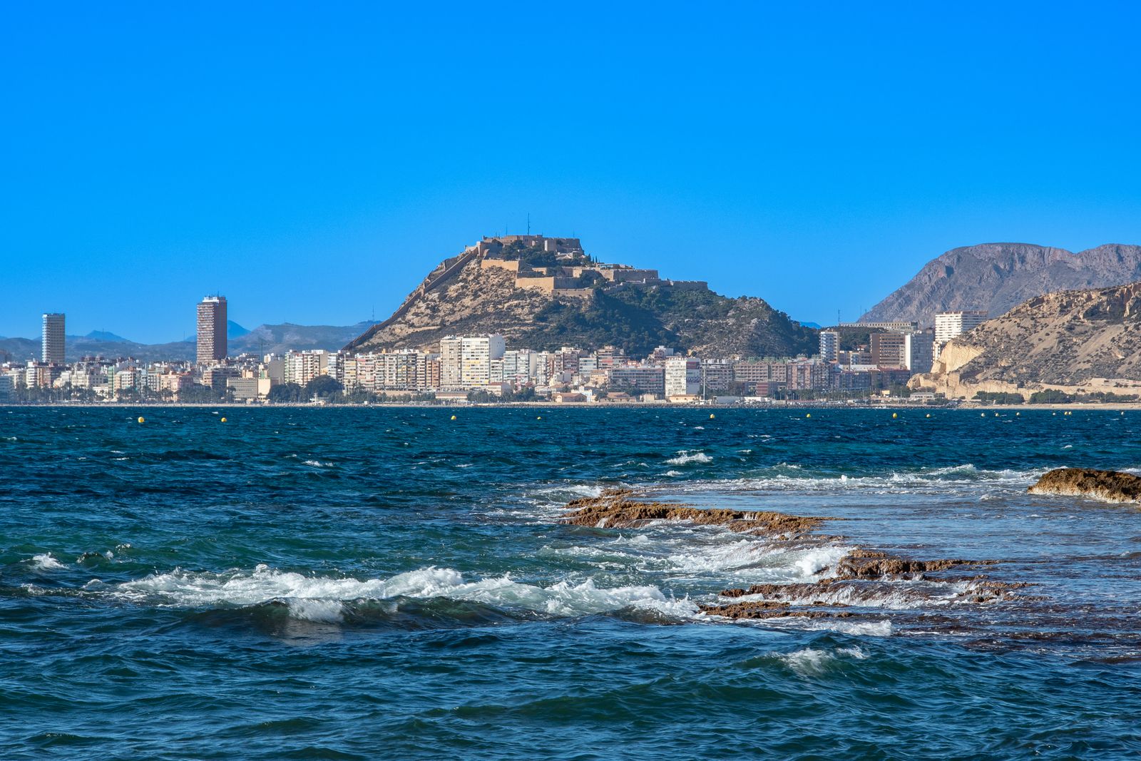 Vista de Alicante desde el mar con el castillo de Santa Bárbara sobre el monte Benacantil y la ciudad al pie