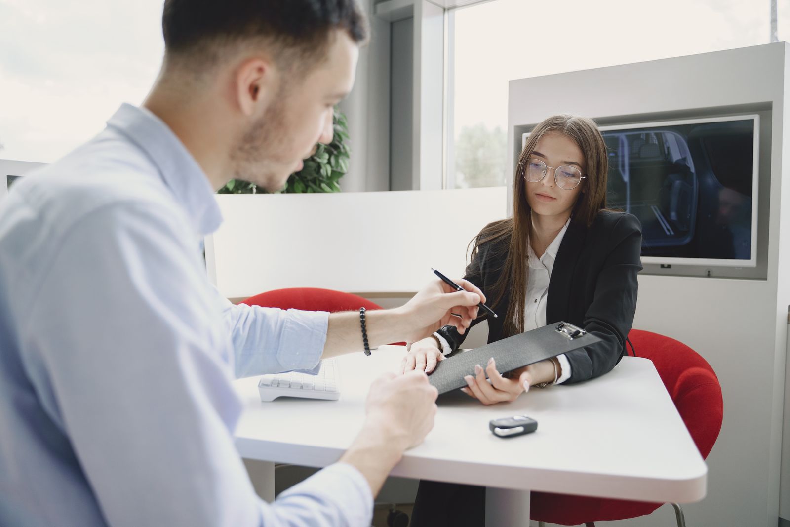 Car keys and rental paperwork on a desk
