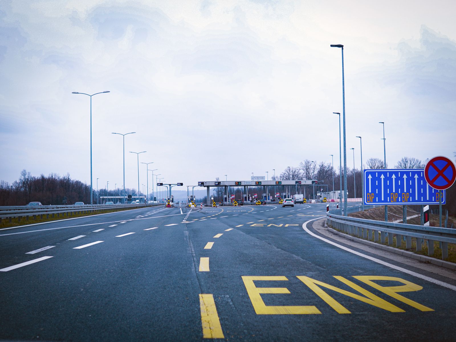 Cars approaching a European motorway toll plaza